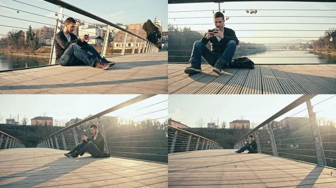 WS男子坐在桥上使用智能手机