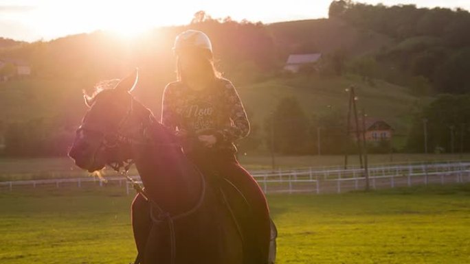 日落时骑马的年轻女子
