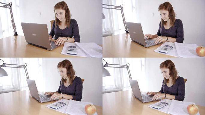 年轻女子在笔记本电脑上学习