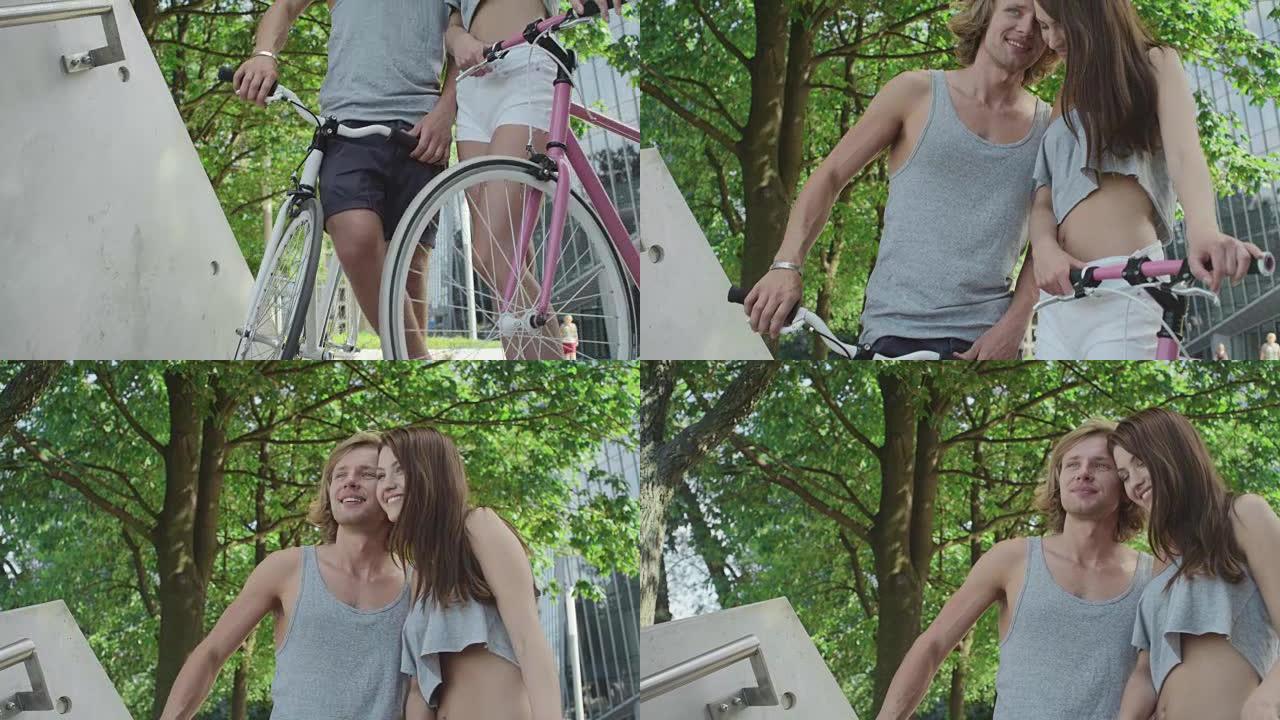 年轻夫妇在现代城市骑自行车