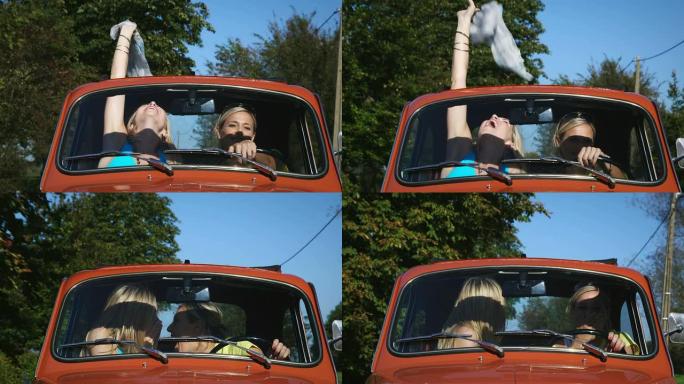 两个女孩开车高兴欢笑漂亮女性