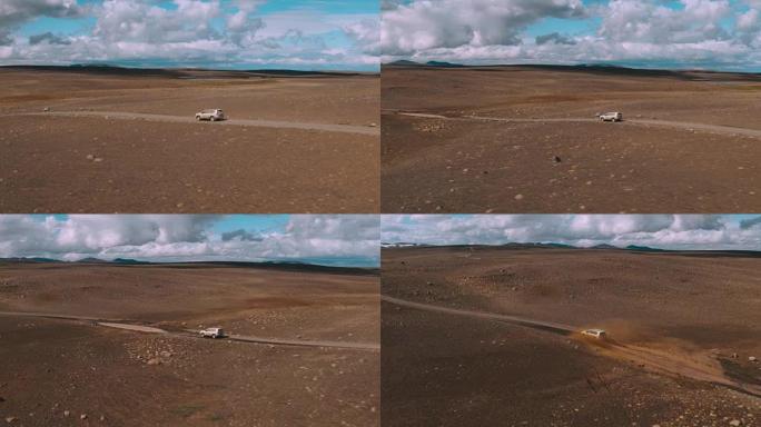 4x4 SUV汽车在沙漠景观中孤立的土路上通过水坑行驶的航拍