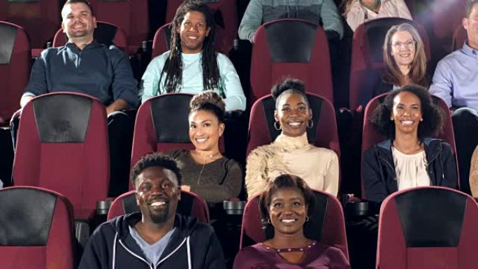 多种族的成年人在剧院看电影