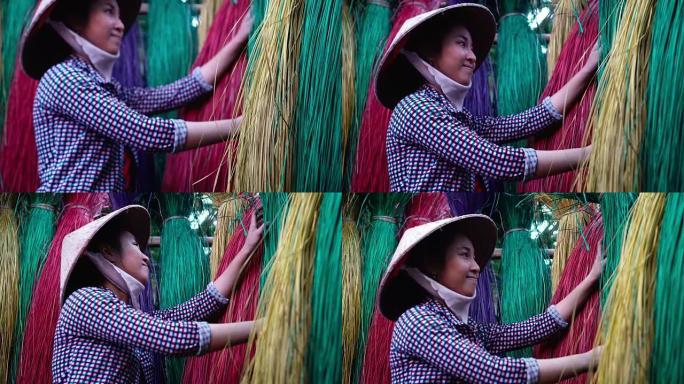 越南女工匠在越南东塔丁延老村干燥和制作传统越南垫子的4k镜头现场，传统艺术家概念