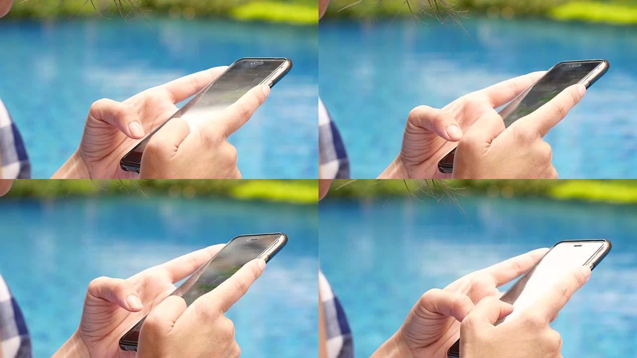在游泳池里使用智能手机，触摸