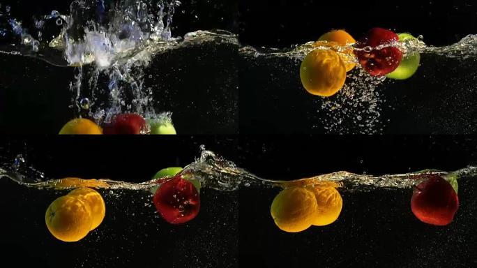 橘子和苹果落水有气泡的慢动作视频。孤立的黑色背景上的水果。