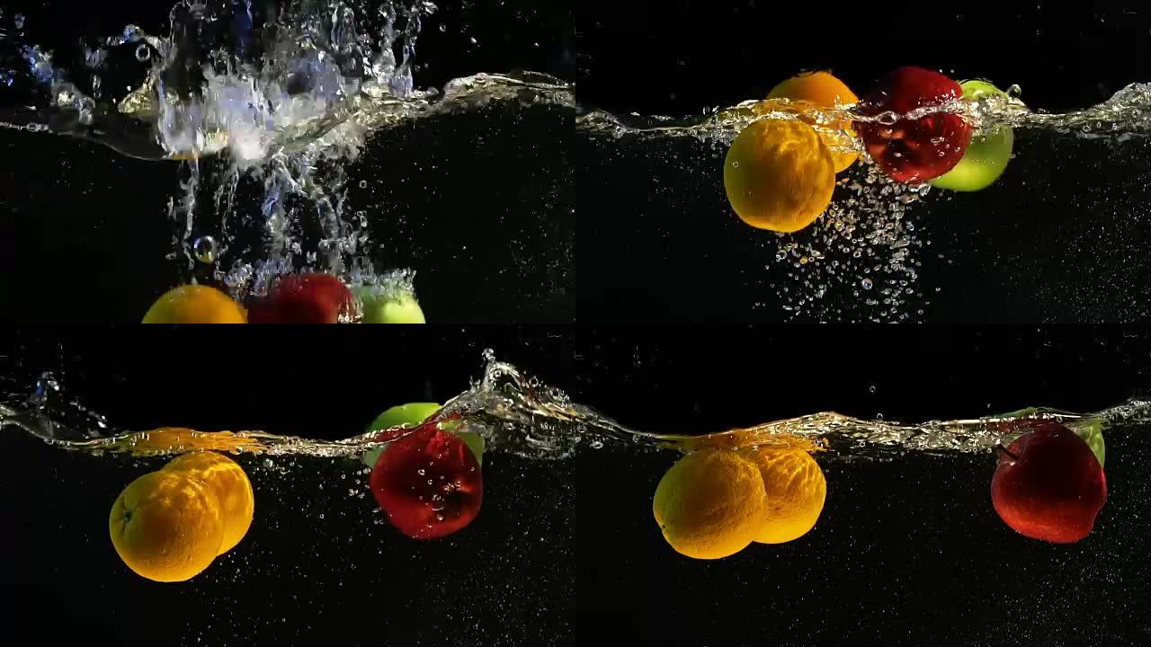 橘子和苹果落水有气泡的慢动作视频。孤立的黑色背景上的水果。