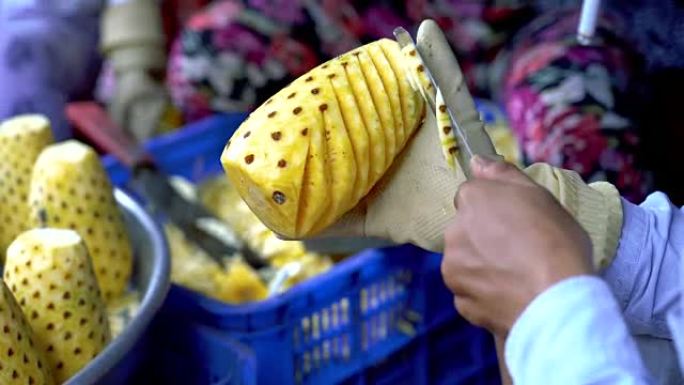 越南芹苴省蔡让市场亚洲商人用刀剥菠萝的4k镜头，新鲜食品市场和蔬菜概念