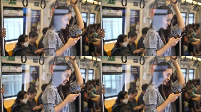 亚洲妇女在乘坐空中火车时使用智能手机，慢动作