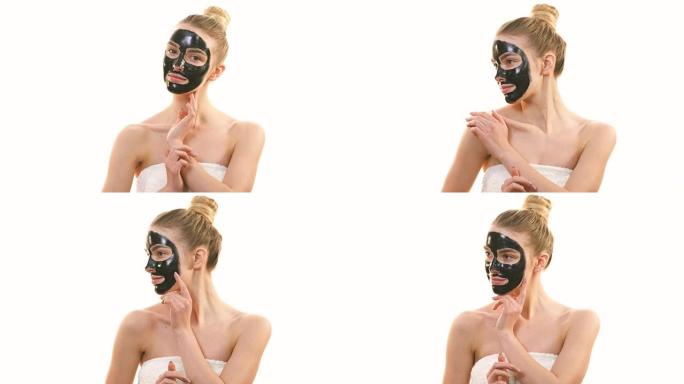 黑脸护理面具的幸福女人在白底调情