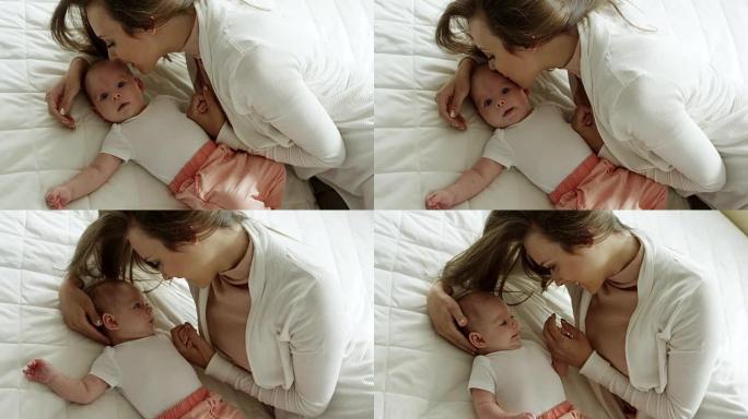母亲在床上亲吻女儿