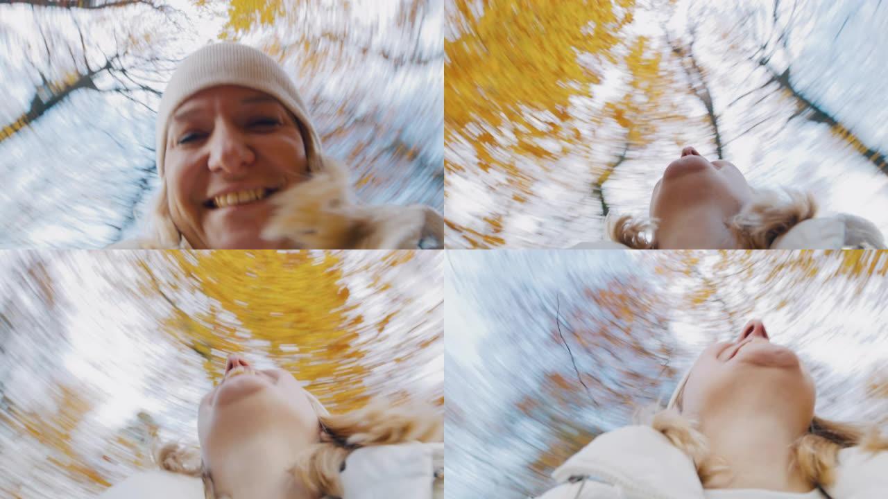 女士肖像无忧无虑的年轻女子在森林中的秋天树木下旋转