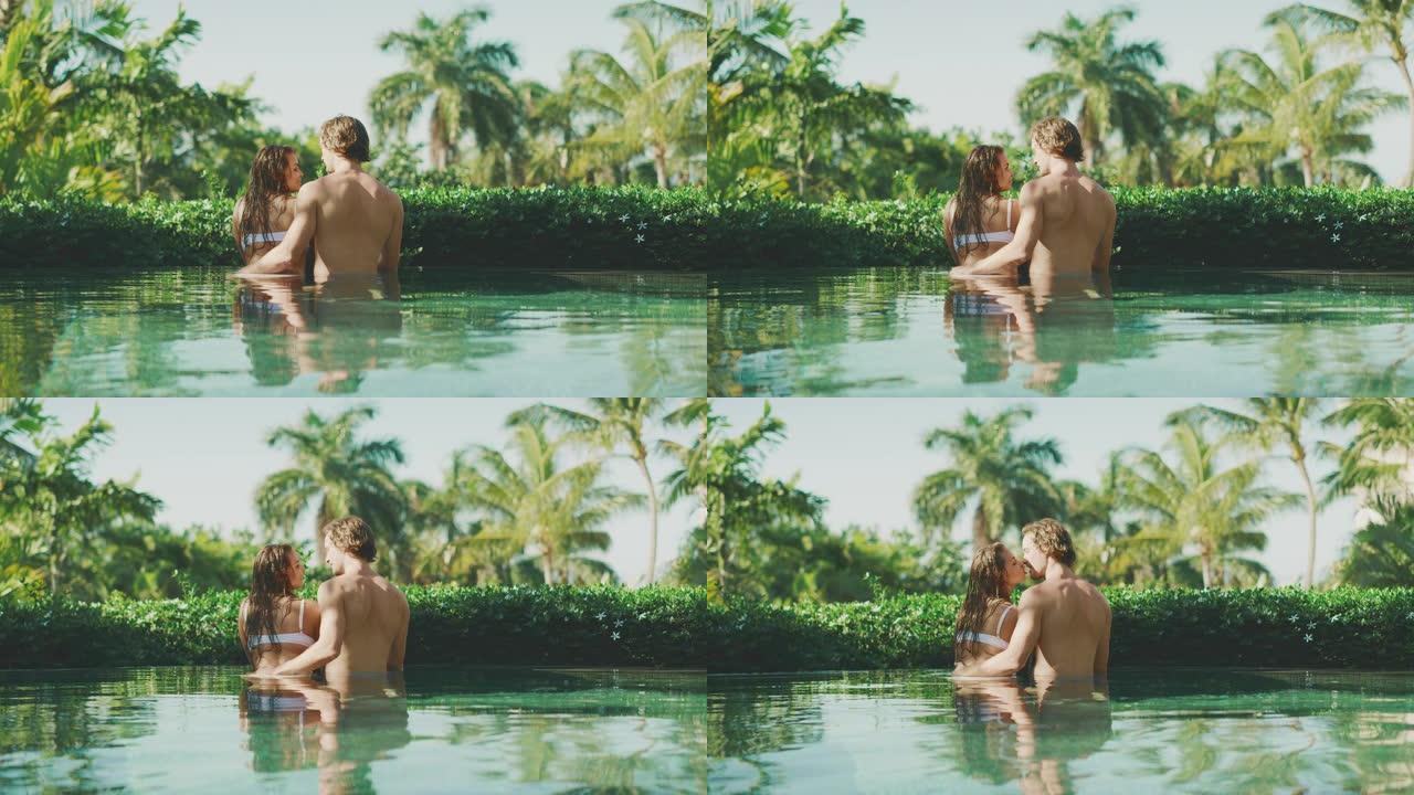 迷人的夫妇享受热带游泳池