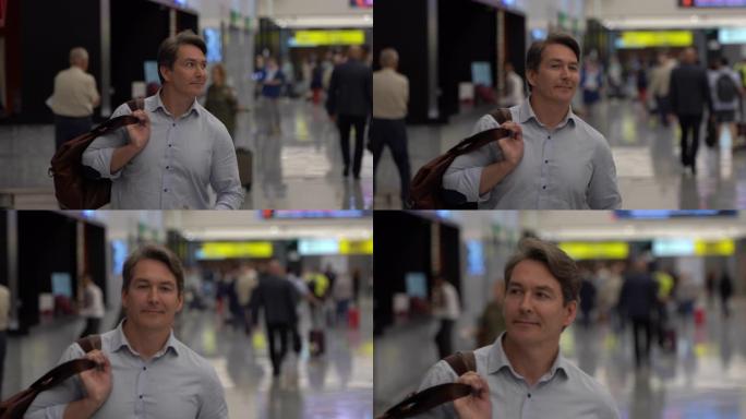 在机场，英俊的单身男人背着行李走路，看起来很开心