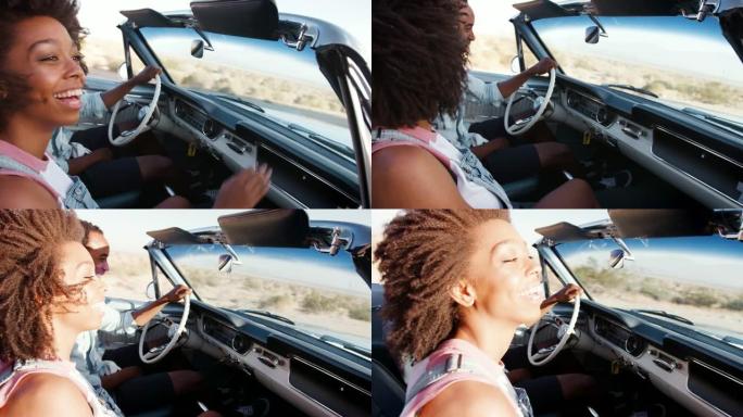 黑人夫妇在沙漠高速公路上开着敞车，特写
