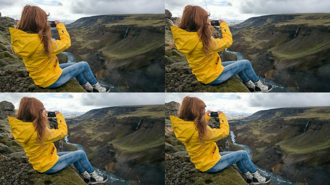 女人坐在峡谷边缘，拍摄令人叹为观止的照片