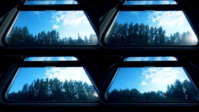 从车厢车厢观看。马车里的大窗户，外面的森林。