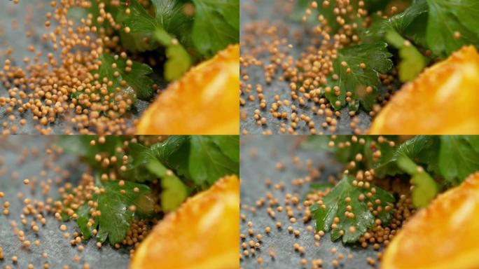 慢动作，宏观: 微小的有机芥末籽落在潮湿的欧芹叶上。