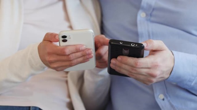 两名男性和女性用户拿着使用应用程序的智能手机，特写镜头