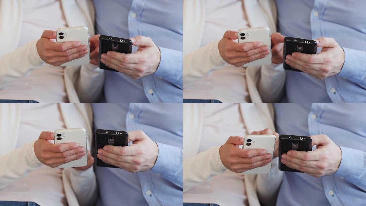 两名男性和女性用户拿着使用应用程序的智能手机，特写镜头