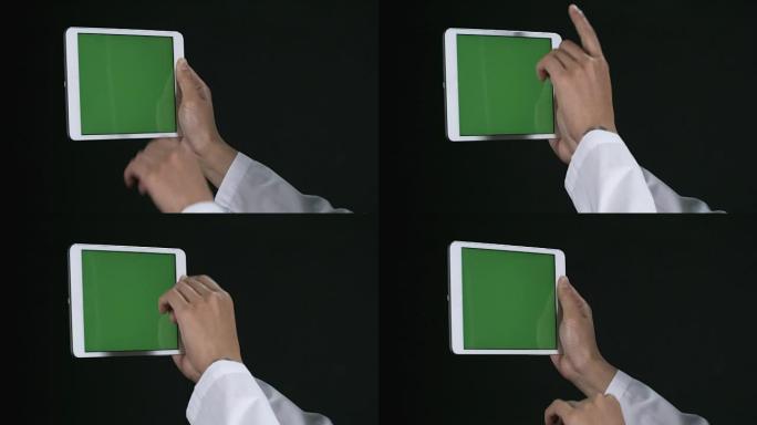 绿色屏幕的平板电脑上的女性手滚动