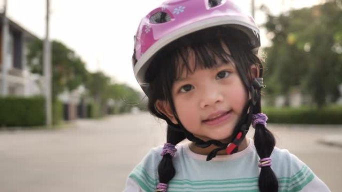 小女孩骑自行车，推动踏板