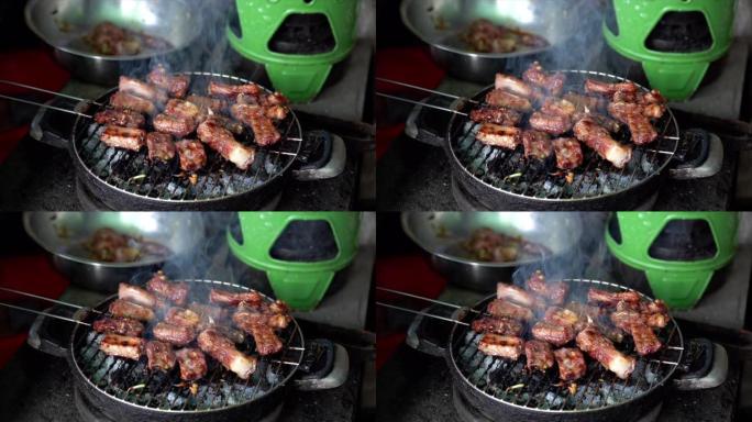 在木炭烤架上烧烤猪肉，烹饪食物和烧烤概念的4k慢动作镜头
