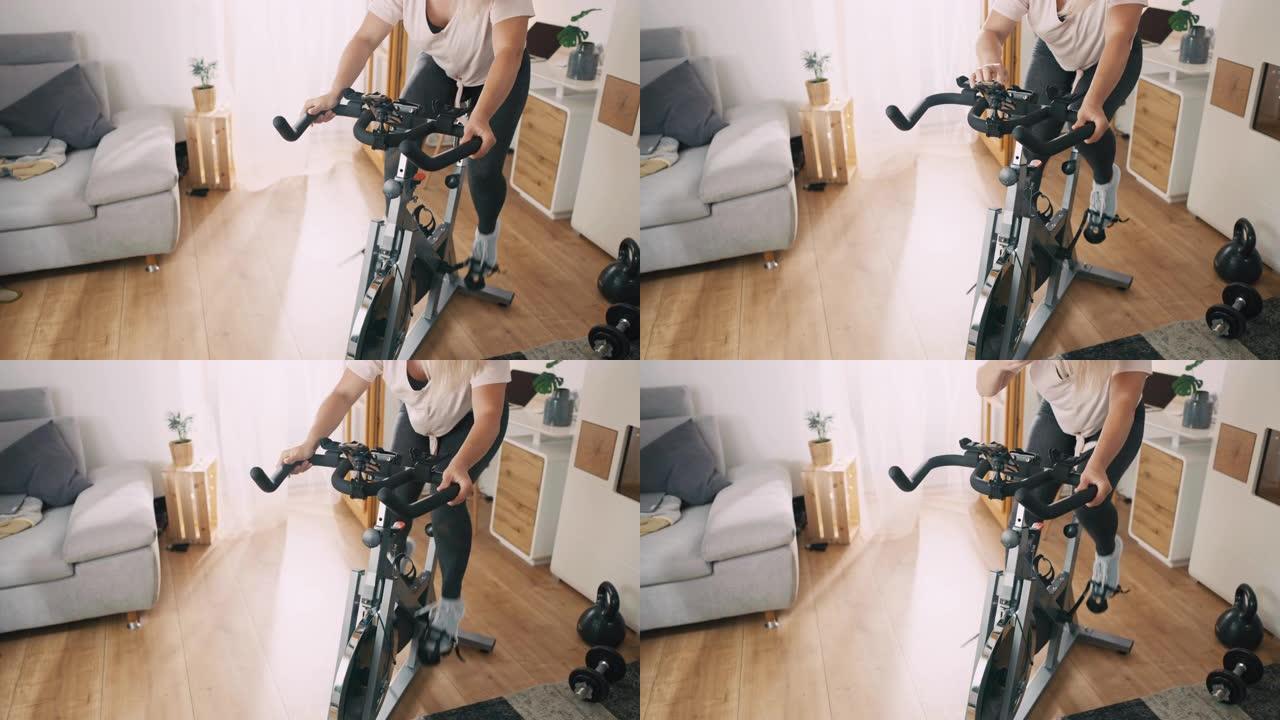SLO MO女人在家骑健身车