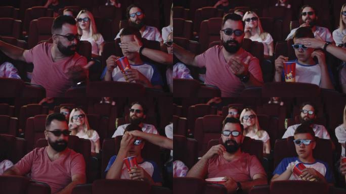 父母在电影院遮住孩子的眼睛