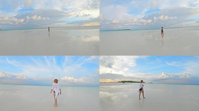 女士在马尔代夫宁静的热带海洋海滩上行走