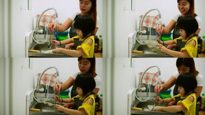 一位亚洲华裔女美术老师在水彩画课后帮助她的学生清理所有画笔