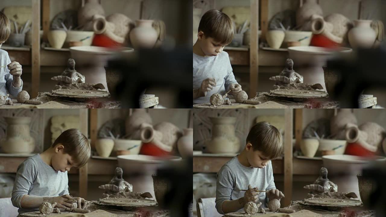 在陶器车间用粘土雕刻男孩