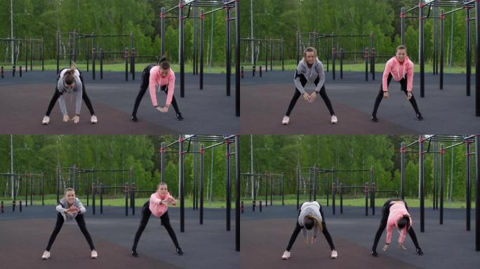 高加索双胞胎姐妹在户外健身房锻炼