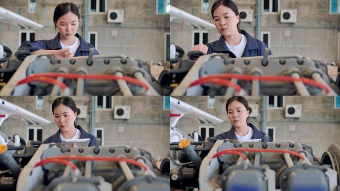 领导亚洲少女在机库飞机中的维护和分析检查飞机的最佳功能以确保信心的发展工程师在机库飞机中的维护。ST