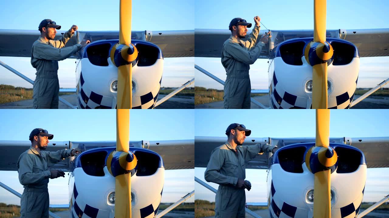 一名男性飞机专家正在检查和清洁飞机的详细信息
