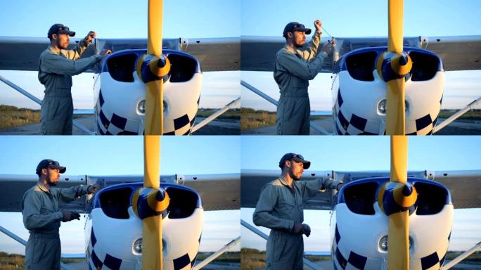一名男性飞机专家正在检查和清洁飞机的详细信息