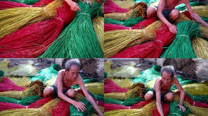4k镜头场景越南老工匠在越南东塔丁延的老传统村庄制作传统越南垫子的俯视图，传统艺术家概念
