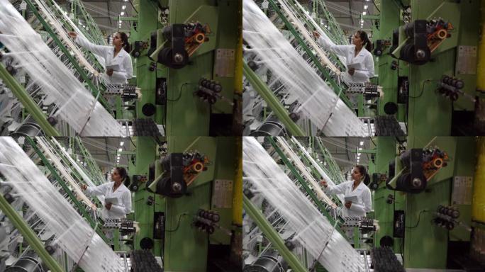 橡胶带工厂的女工拿着平板电脑检查生产