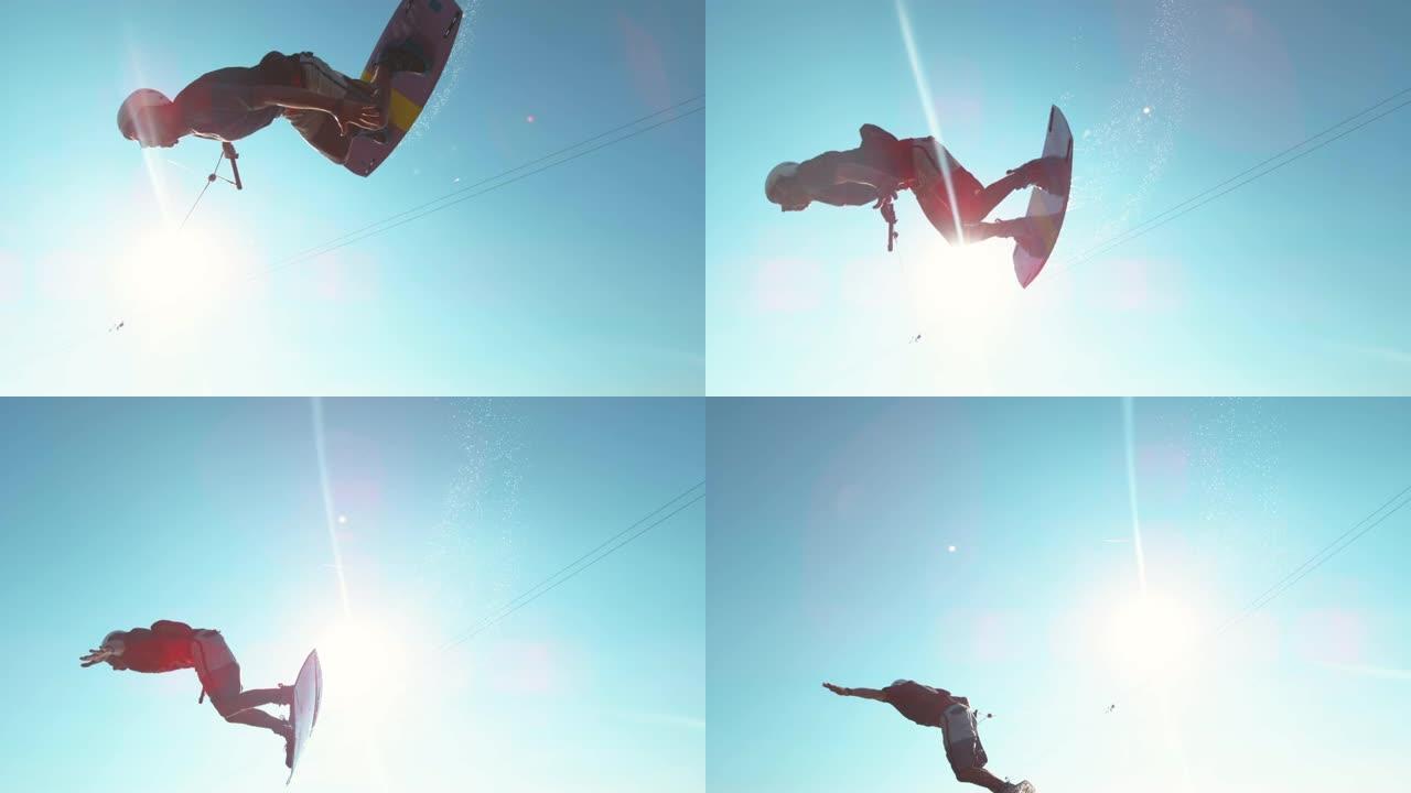 镜头耀斑: 快乐的wakesurfer在飞越相机时做了一个很酷的翻转技巧