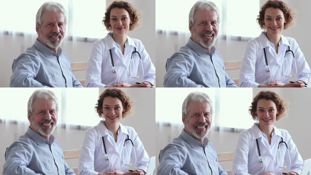 微笑的高级男性患者探望女医生看着相机