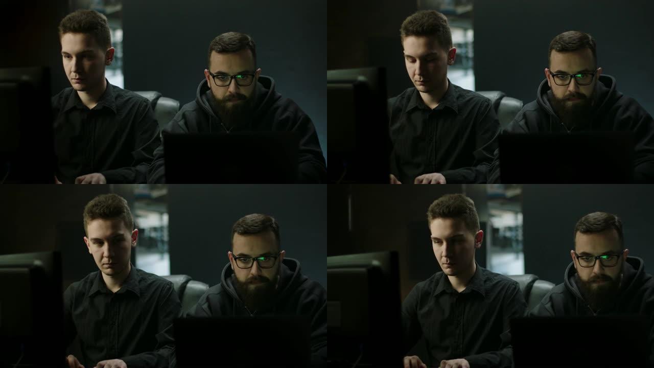电脑黑客一起在电脑上工作
