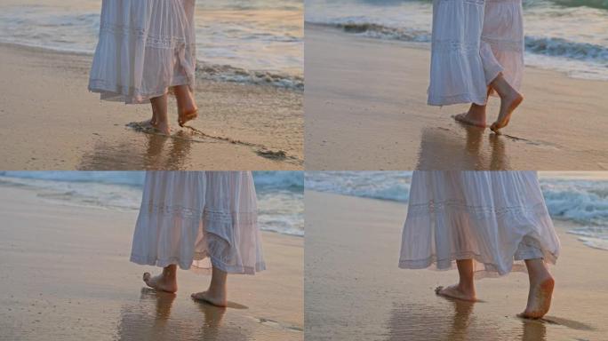 穿着蕾丝白色裙子的女人赤脚慢慢走在潮湿的沙滩上。海浪冲刷海岸。