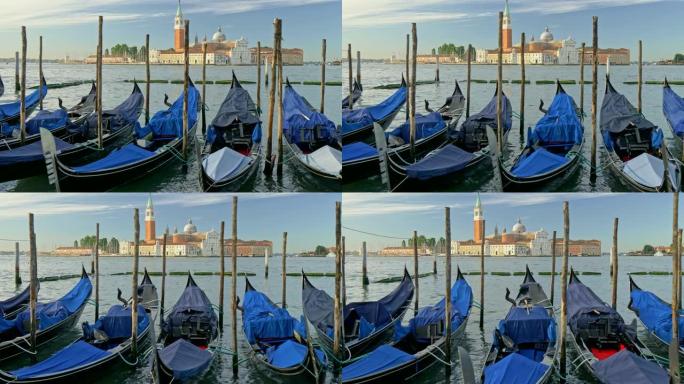 意大利威尼斯。覆盖着蓝色防水布的岸边吊船。背景中可以看到圣马克大教堂和钟楼。万向节射击。4K, UH