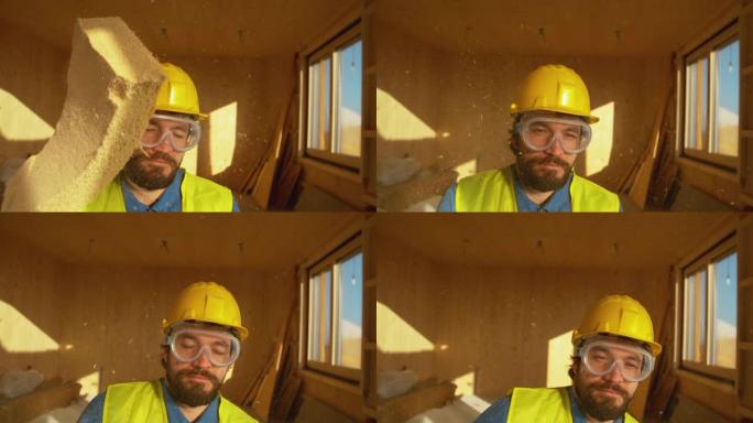 肖像: 戴着安全帽的建筑工人被一块泡沫击中