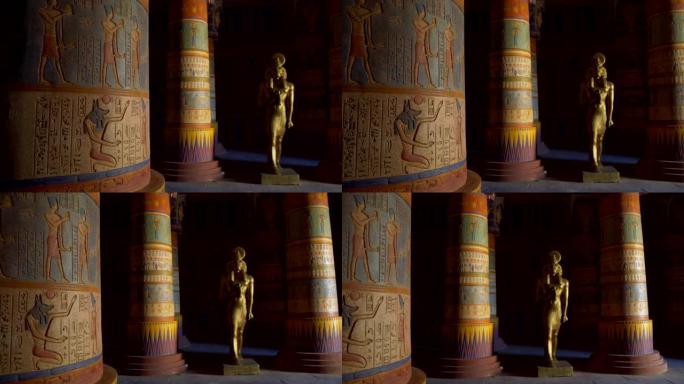 埃及寺庙的内部。五颜六色的柱子上覆盖着古埃及的人物和古代人生活的图片。公羊头神Khnum (尼罗河源