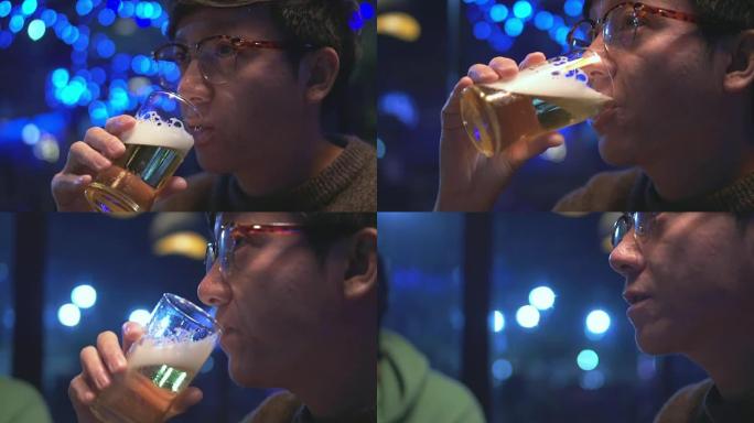 年轻人喝啤酒的特写，慢镜头