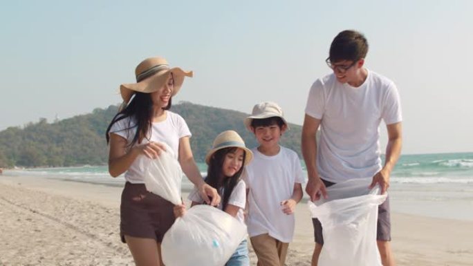 亚洲年轻的幸福家庭活动家收集塑料垃圾并在海滩上散步。