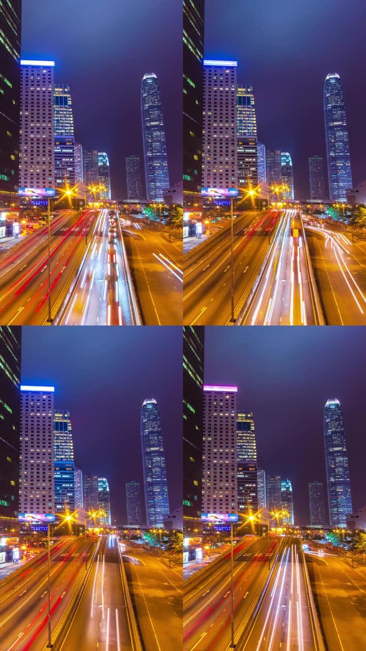 (垂直) 交通延时和香港摩天大楼城市景观在夜间。
