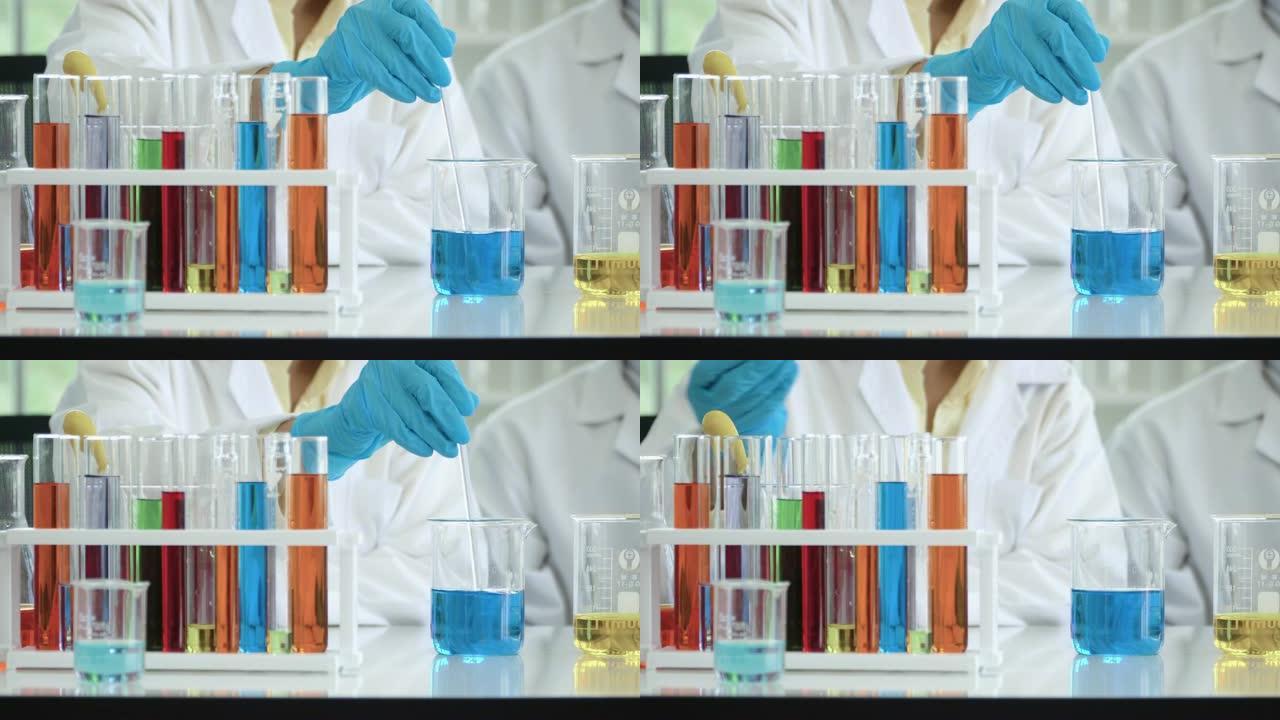 4k: 科学家在实验室的烧杯中分析和混合液体。