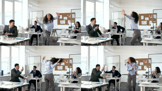 无忧无虑的女人在办公室的业务团队面前跳舞